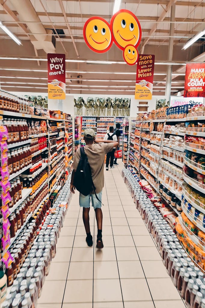 Home 7 A shopper walks through a colorful grocery store aisle, lively atmosphere. Retail data with Peoplefindersdaas.